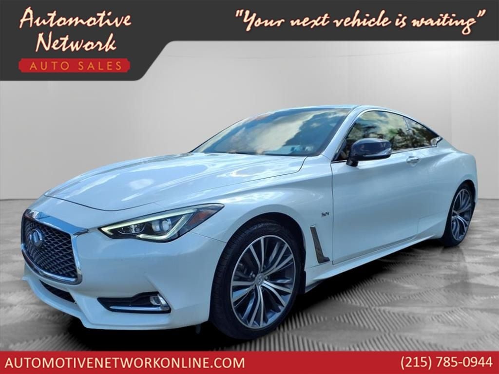 2018 INFINITI Q60 3.0t LUXE in Majestic White — front three-quarter view